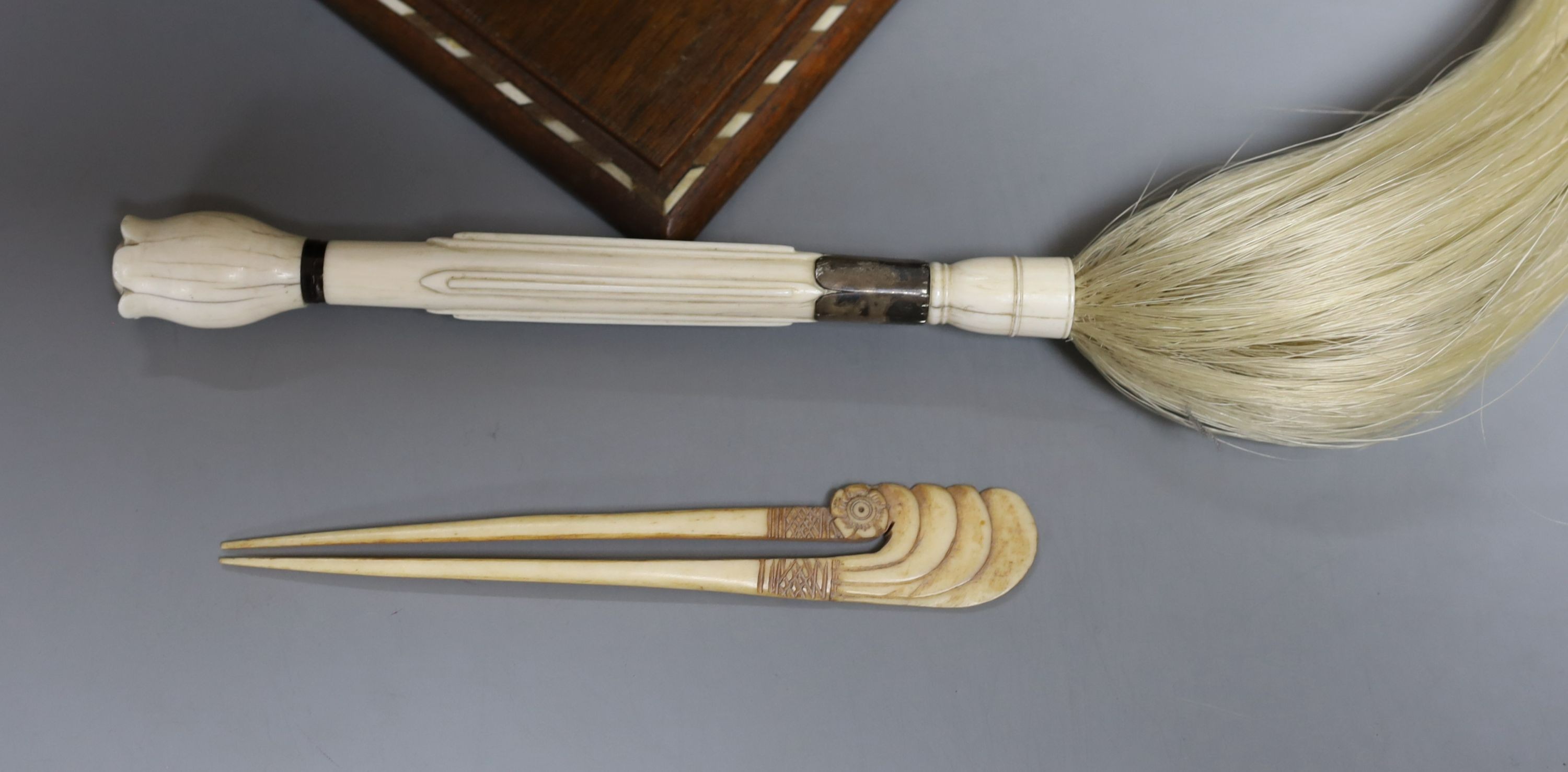 A 19th century ivory handled fly whisk, ivory inlaid sandalwood glove box, carved bone snuff box, bone inlaid cigarette box, a Burmese lacquer panel and a Persian painted ivorine panel